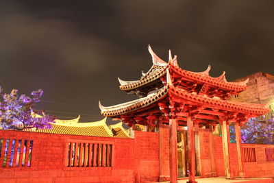 Low angle view of illuminated building against sky