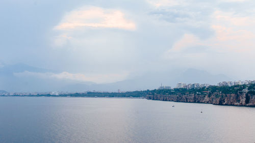 Scenic view of sea against sky in city