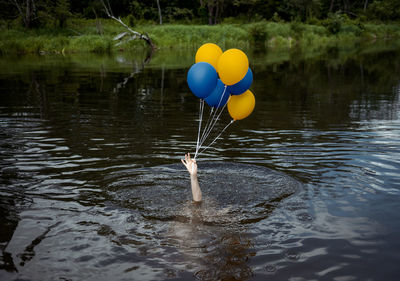 View of balloons on lake