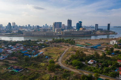 High angle view of road by buildings against sky