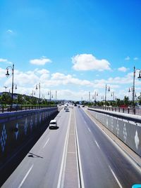 Vehicles on highway against sky