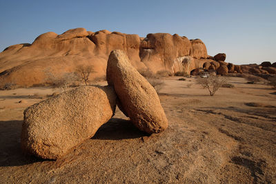 Rock formations in desert against sky