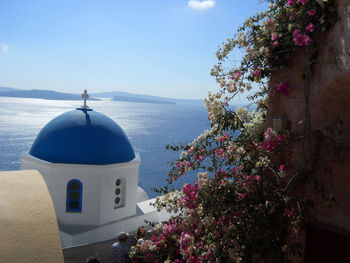 Scenic view of sea by building against sky