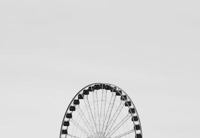 Low angle view of ferris wheel against clear sky