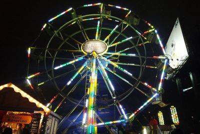 Low angle view of ferris wheel at night