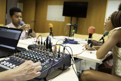 Side view of woman using laptop at home