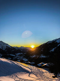 Scenic view of snow covered mountains against sky