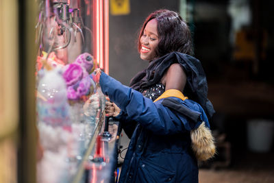 Black woman playing claw crane