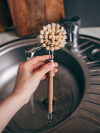 Dishwashing brush on the table in hand