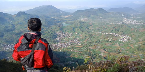 Rear view of man standing on mountain