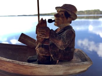Close-up of statue on table against sea