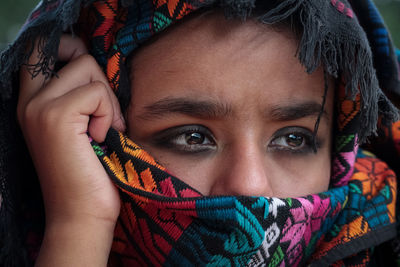 Close-up portrait of girl covering face