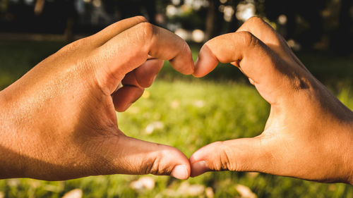 Close-up of hands holding heart shape
