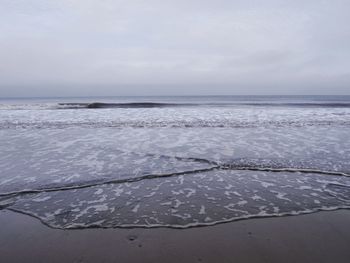 Scenic view of sea against sky during winter