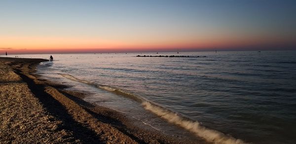 Scenic view of sea against clear sky during sunset