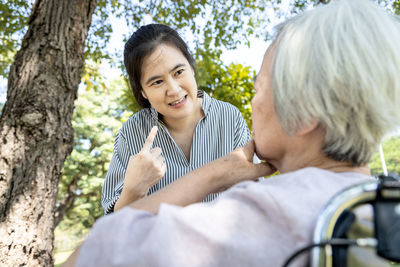 Portrait of a smiling young woman sitting outdoors