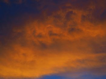 Low angle view of orange cloudy sky