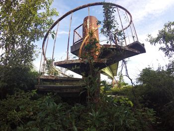 Rusty metallic structure against trees