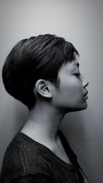 Side view of boy against white background