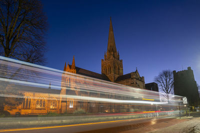 Low angle view of light trails on road at night