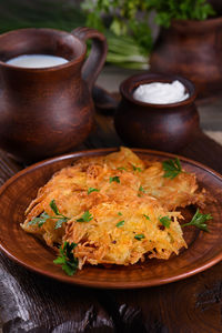 Potato fritters a pancake, especially one made with grated potato served with sour cream