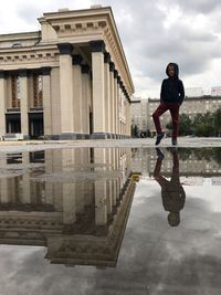 Reflection of man standing in puddle