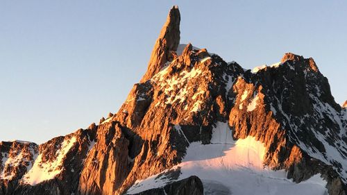 Scenic view of mountains against clear sky during winter