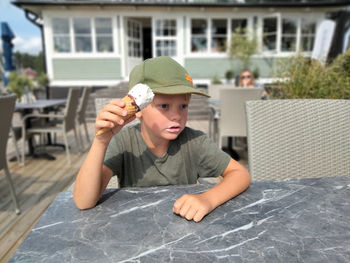 Portrait of boy holding hat