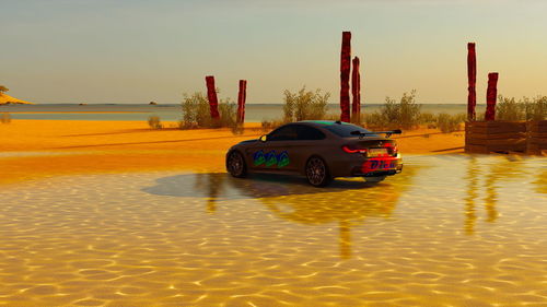 Toy car on land against sky during sunset