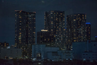 Illuminated buildings in city at night