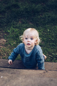 Portrait of cute baby girl leaning on steps