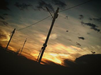 Low angle view of electricity pylon against sky