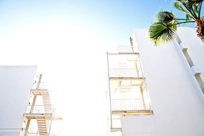 Low angle view of ladder by building against clear sky