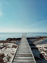 Pier over sea against sky