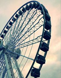 Low angle view of ferris wheel against sky