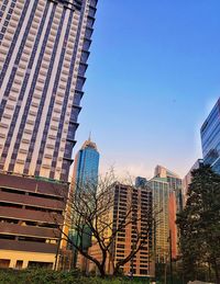 Low angle view of skyscrapers against clear sky