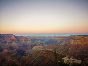 Scenic view of landscape against clear sky during sunset