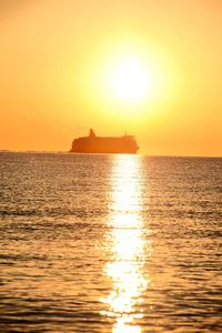 Scenic view of sea against orange sky