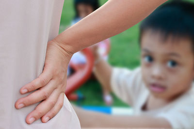 Portrait of boy with mother outdoors