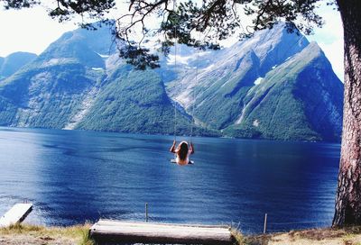 Scenic view of person in sea against mountains