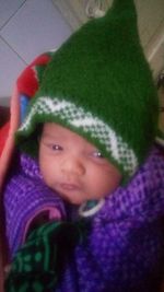 Portrait of cute baby girl lying down at home