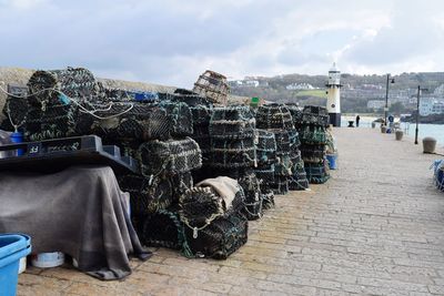 Panoramic shot of crabs traps  by sea against sky in city