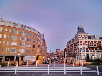 Buildings in city against clear sky