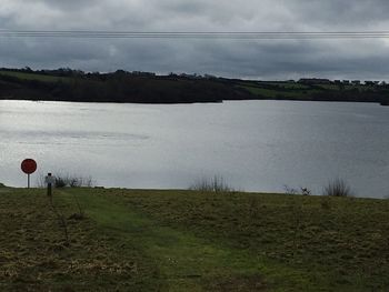 Scenic view of field against cloudy sky