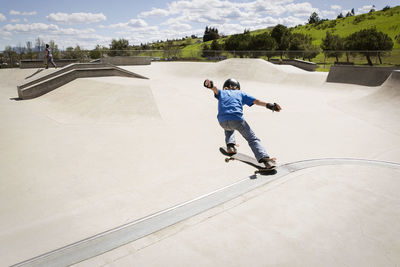 High angle view of boy performing stunt on skateboard ramp