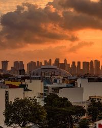 View of cityscape against cloudy sky during sunset