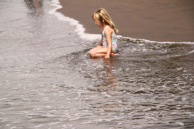 Full length of woman enjoying in water