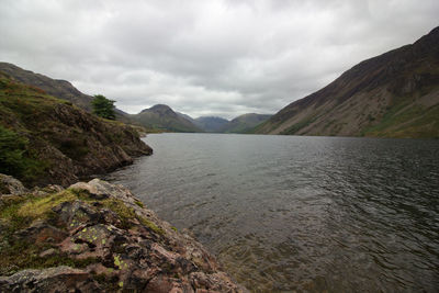 Scenic view of river amidst mountains against sky