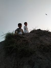 Man and son on land against sky