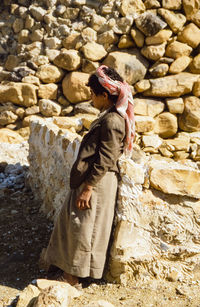 Side view of a man standing on rock